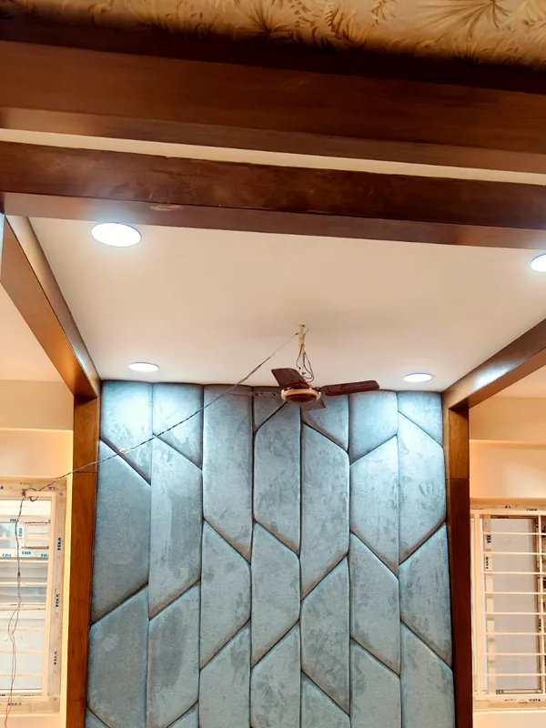 A chevron upholstered wall behind the bed.