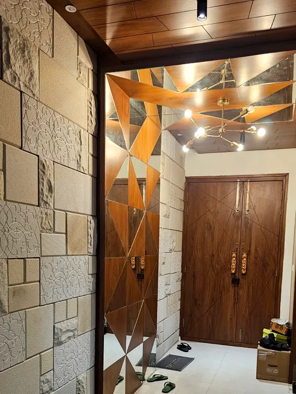 Stone cladding under a faceted timber ceiling.