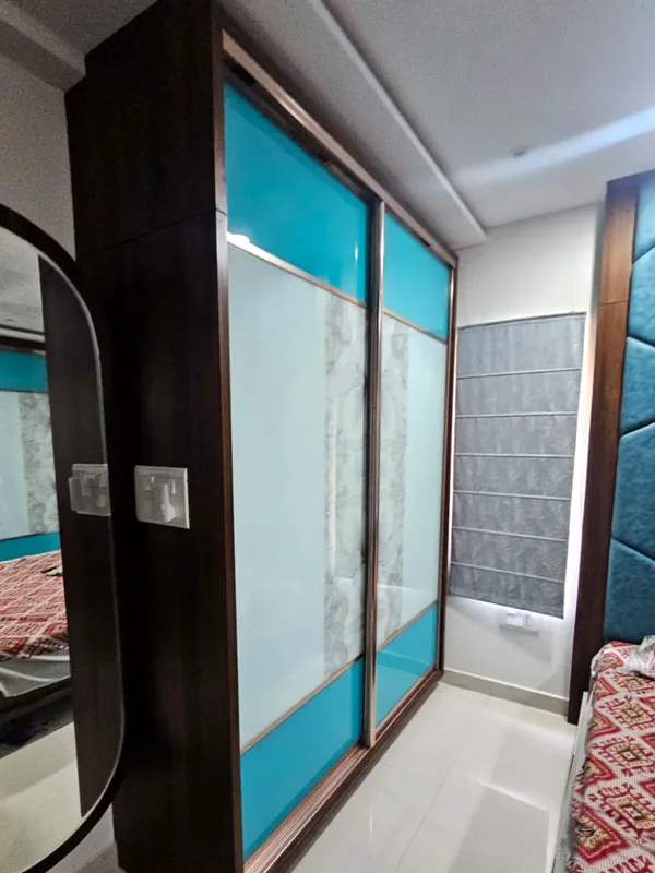 Teal glass sliding doors in a dark timber frame.